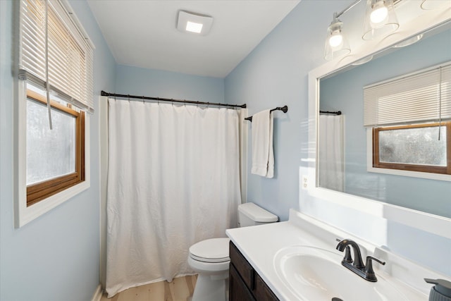 bathroom featuring vanity, curtained shower, toilet, and wood finished floors