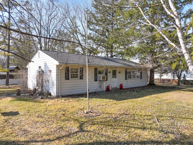 ranch-style home featuring cooling unit and a front yard