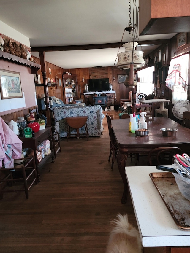 dining room featuring wooden walls and wood finished floors