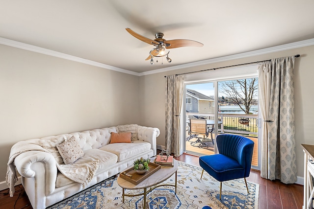 living area with baseboards, a ceiling fan, dark wood-style flooring, and ornamental molding