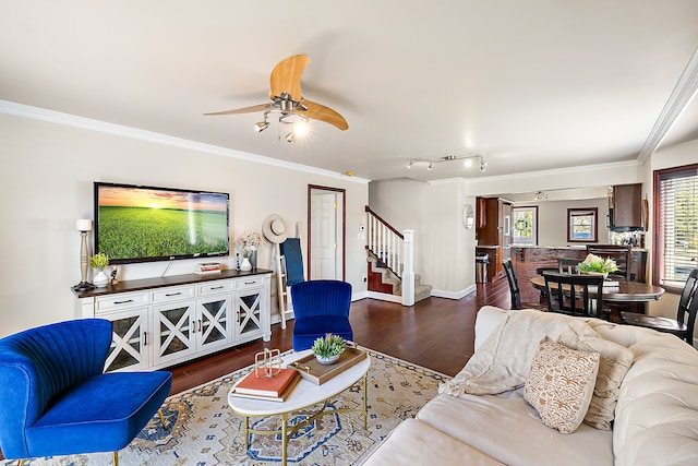 living area with crown molding, stairway, and wood finished floors