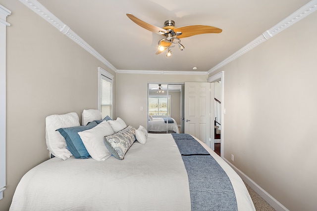 bedroom with ceiling fan, carpet, baseboards, and ornamental molding