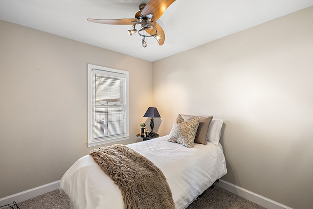 bedroom with a ceiling fan, baseboards, and carpet floors