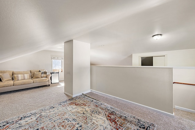 bonus room with baseboards, lofted ceiling, and carpet floors