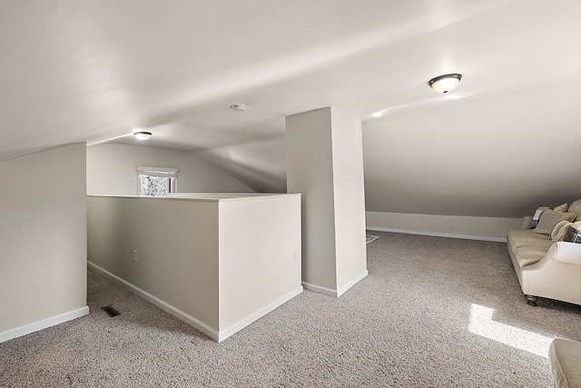 bonus room featuring lofted ceiling, visible vents, baseboards, and carpet floors