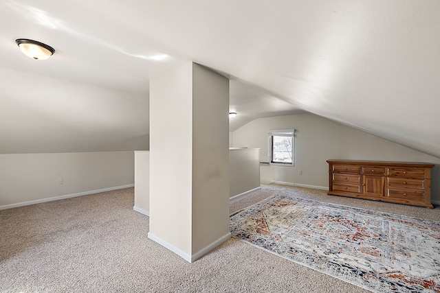 additional living space featuring baseboards, carpet, and vaulted ceiling