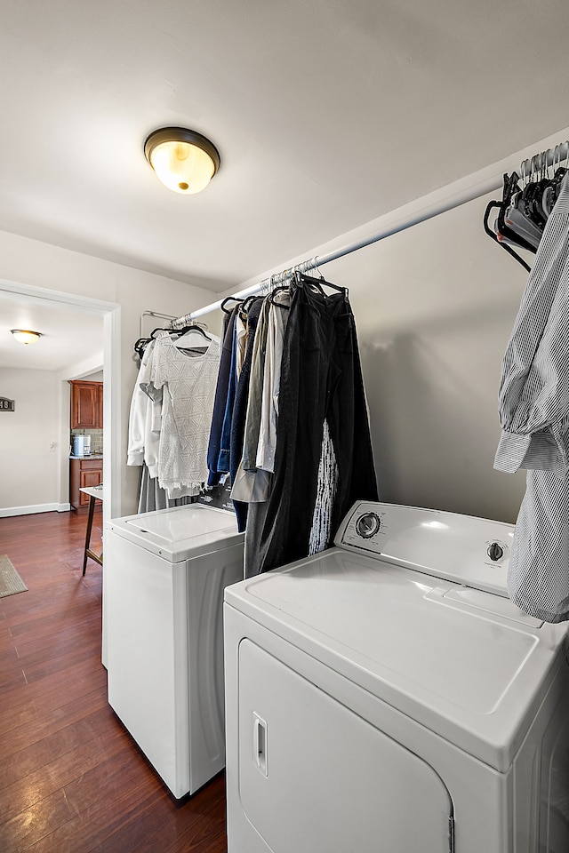 laundry room with washer and dryer, laundry area, dark wood finished floors, and baseboards