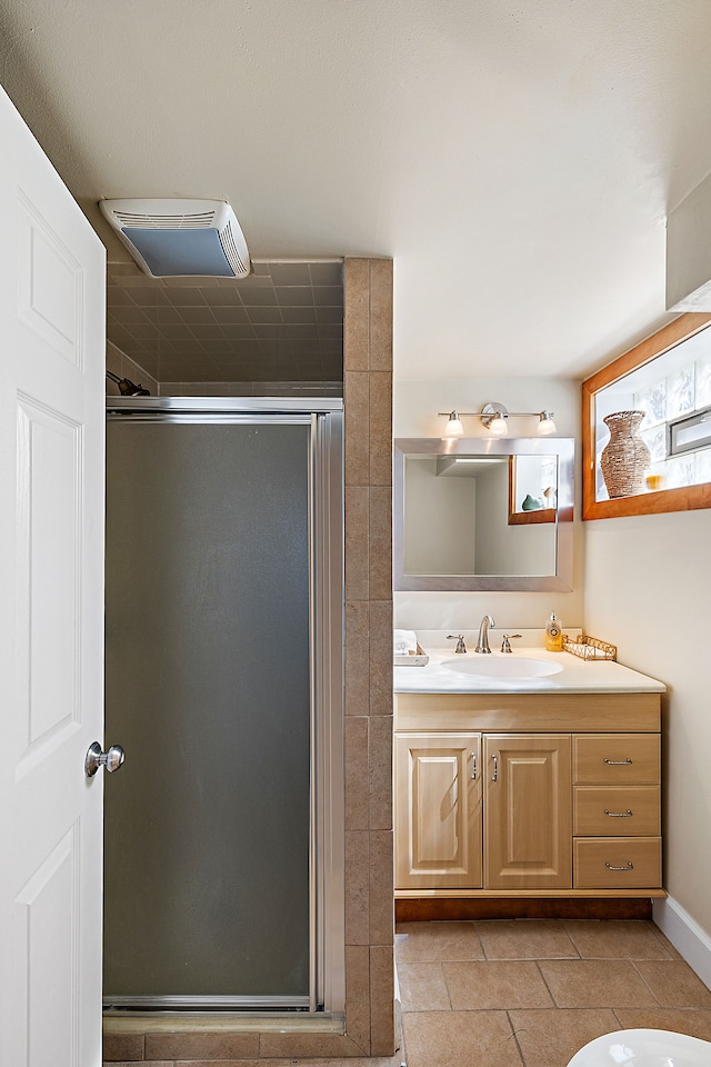 bathroom with vanity, a shower stall, and tile patterned flooring