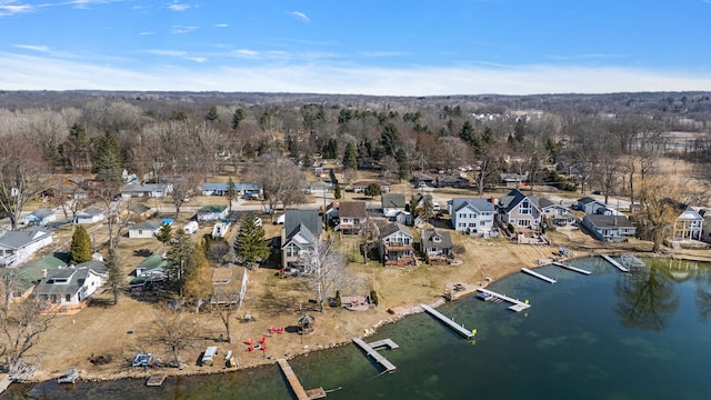 drone / aerial view featuring a residential view and a water view