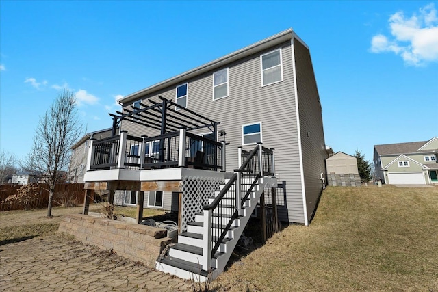 rear view of property with a lawn, a deck, a pergola, fence, and stairway