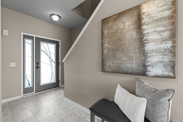 foyer featuring visible vents, marble finish floor, and baseboards