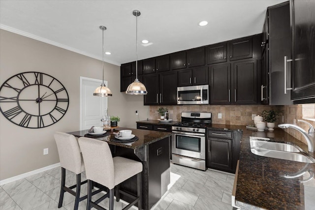 kitchen with tasteful backsplash, a sink, appliances with stainless steel finishes, marble finish floor, and dark cabinets