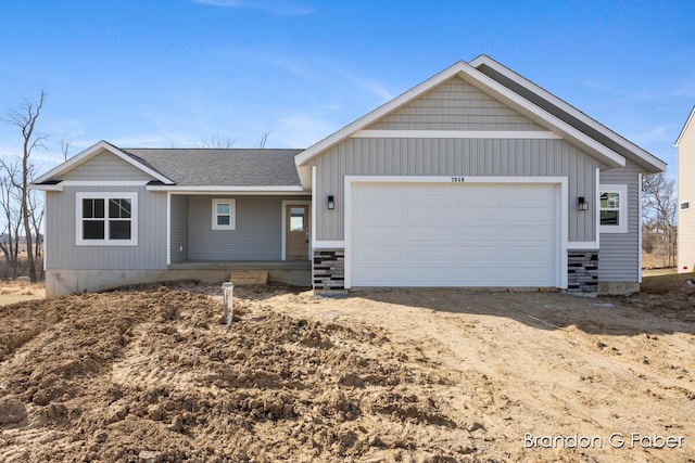 ranch-style house with dirt driveway, a porch, an attached garage, and a shingled roof