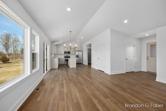 unfurnished living room with visible vents, lofted ceiling, dark wood-type flooring, and an inviting chandelier