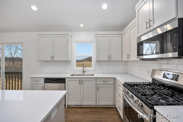 kitchen featuring a sink, appliances with stainless steel finishes, recessed lighting, and light countertops