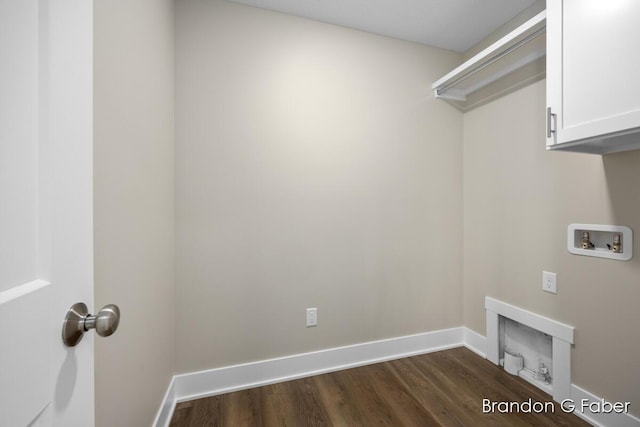 laundry room featuring cabinet space, hookup for a washing machine, dark wood-type flooring, and baseboards