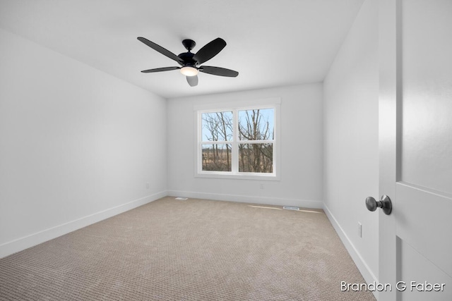 empty room featuring baseboards, ceiling fan, and carpet flooring