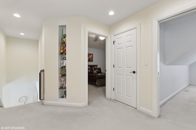 corridor featuring recessed lighting, baseboards, and light carpet