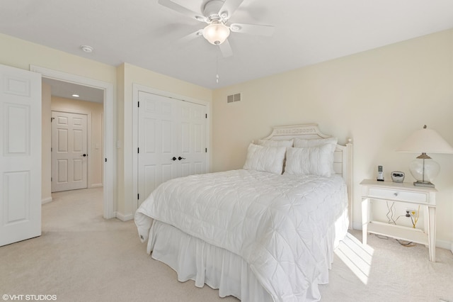 bedroom featuring visible vents, baseboards, light colored carpet, and a closet