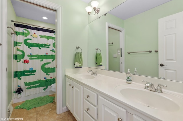 full bath with double vanity, toilet, tile patterned floors, and a sink