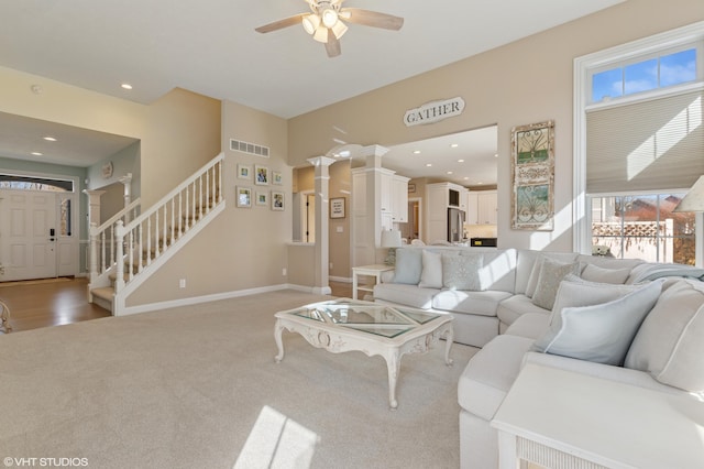 living room featuring stairway, baseboards, visible vents, recessed lighting, and ceiling fan