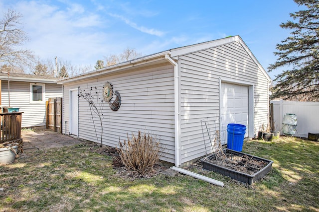 detached garage featuring fence