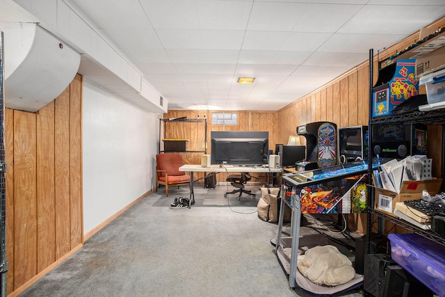 home office with carpet and wood walls