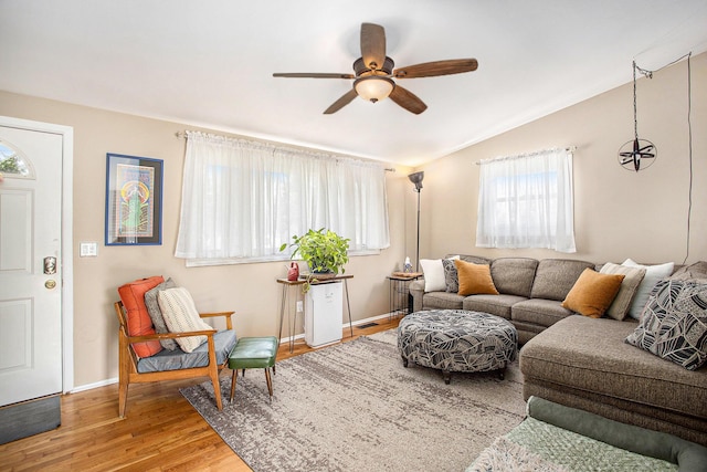 living room featuring lofted ceiling, wood finished floors, a wealth of natural light, and ceiling fan