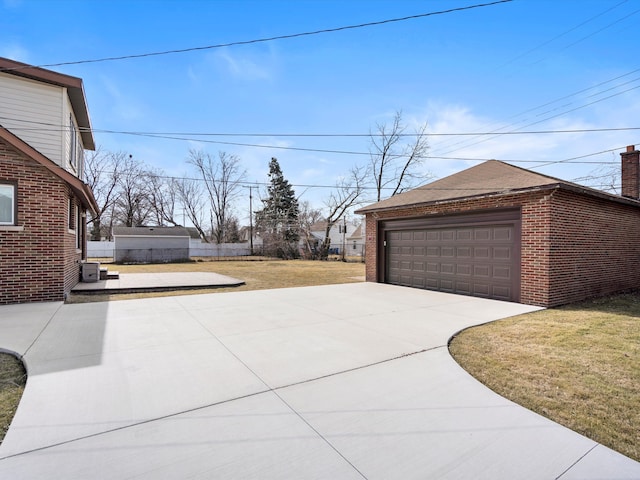 exterior space with an outbuilding and a detached garage