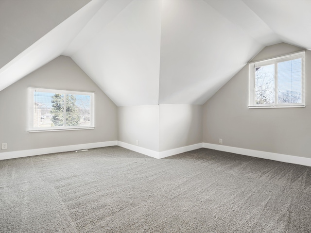 bonus room featuring vaulted ceiling, baseboards, and carpet floors