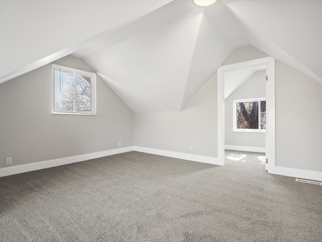 bonus room featuring a wealth of natural light, visible vents, and baseboards