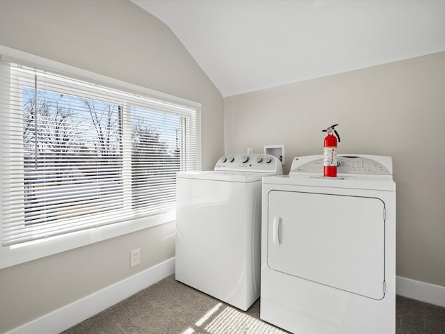 washroom with baseboards, light colored carpet, laundry area, and washer and clothes dryer