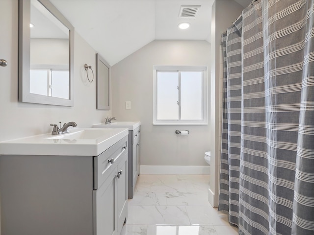 bathroom with a wealth of natural light, baseboards, marble finish floor, and vaulted ceiling