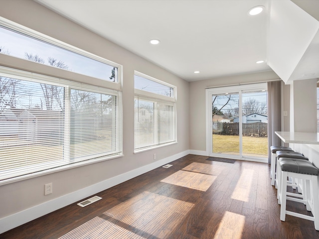 interior space featuring visible vents, recessed lighting, dark wood-type flooring, and baseboards