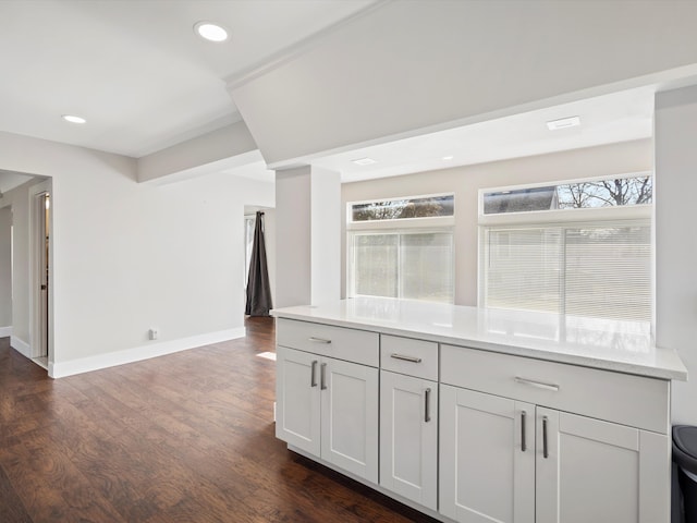 kitchen with dark wood-type flooring, recessed lighting, light countertops, and baseboards