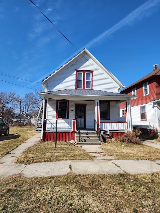 bungalow-style house with a porch and a front yard