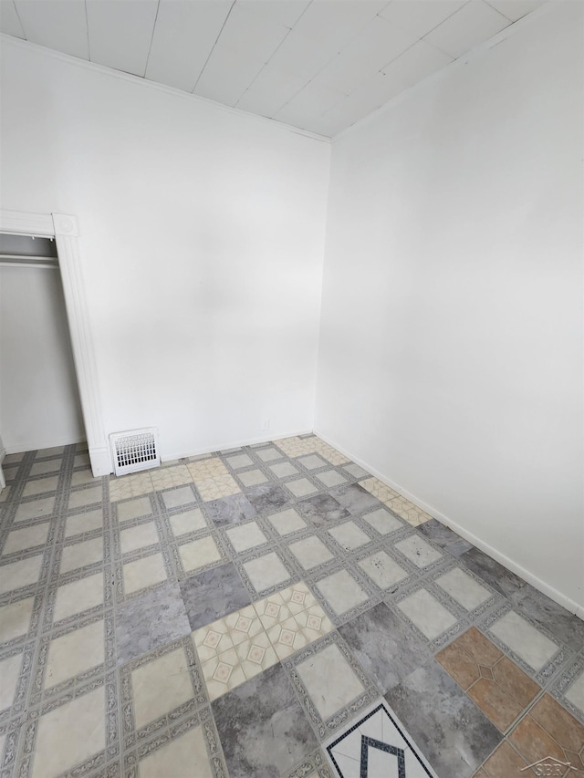 unfurnished room featuring tile patterned floors, baseboards, and visible vents