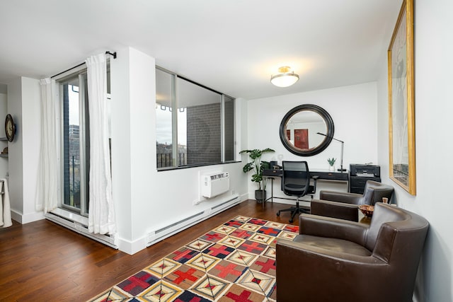 sitting room featuring wood finished floors, baseboards, and a baseboard radiator