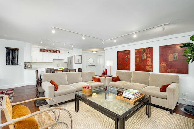 living room featuring wood finished floors and baseboards