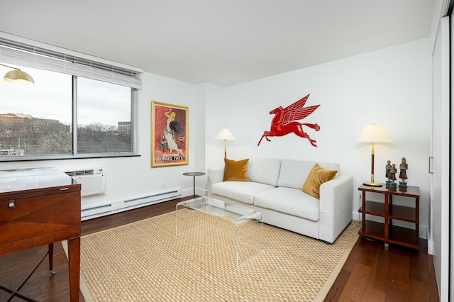 living room with a baseboard heating unit, dark wood-style floors, and a wall mounted air conditioner