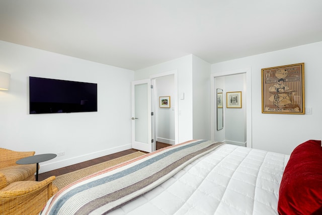 bedroom featuring baseboards and wood finished floors