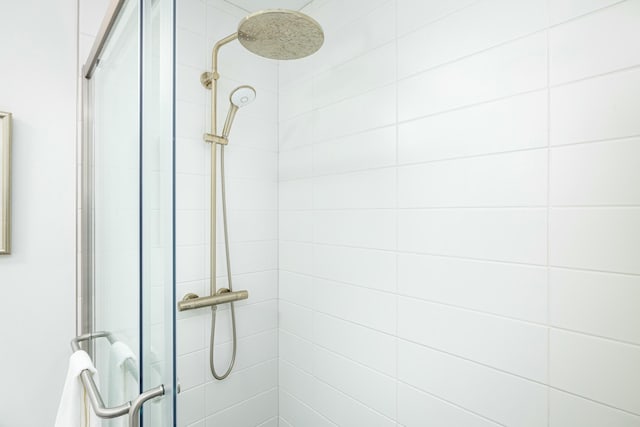 full bath with a tile shower