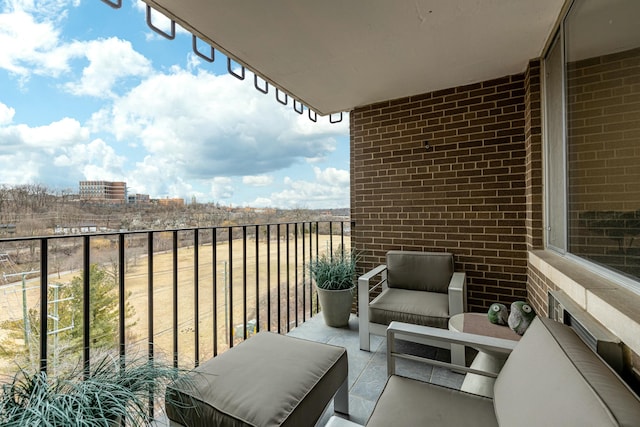 balcony featuring a city view and an outdoor hangout area