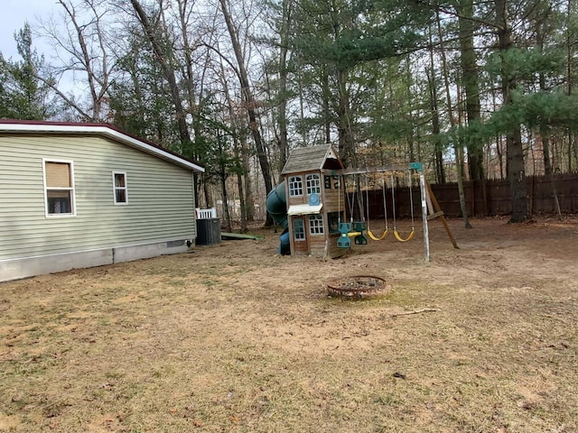 view of yard featuring a playground and fence