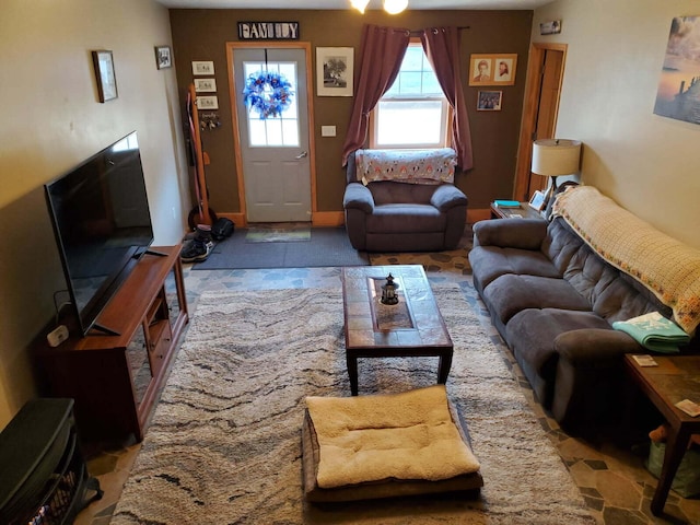 living room with stone finish flooring and baseboards