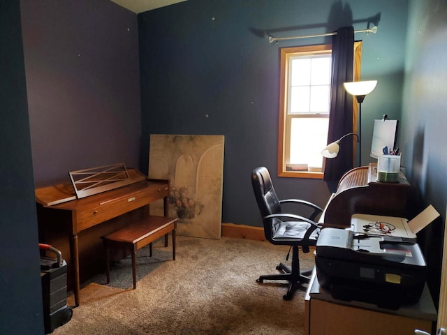 carpeted office featuring baseboards