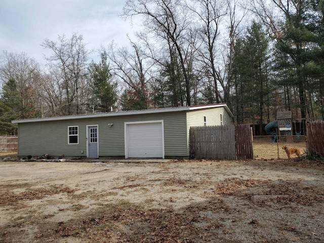 detached garage featuring fence