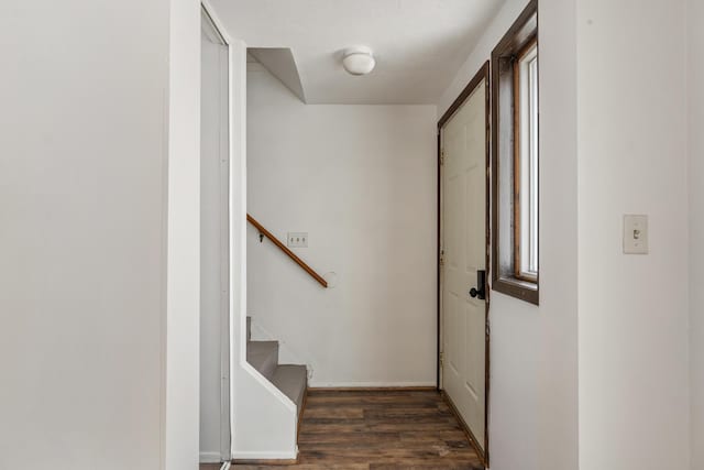 hall with stairway, wood finished floors, and baseboards