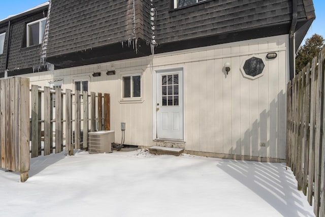 exterior space with a patio, mansard roof, fence, and a shingled roof