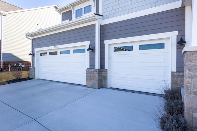 garage featuring concrete driveway